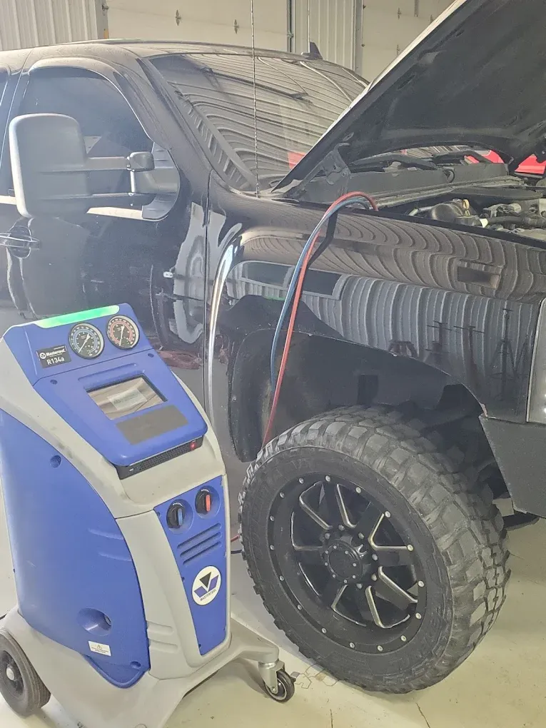 Robinair R134a AC recovery and recharge machine connected to a customer truck