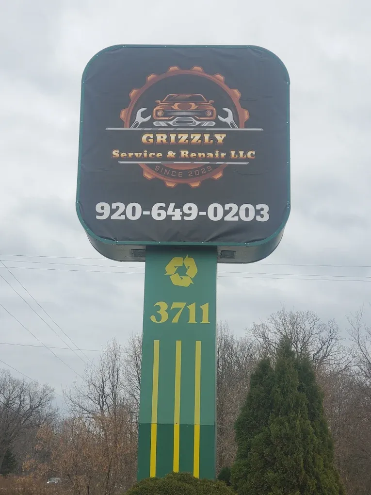 Grizzly Service & Repair LLC roadside sign with phone 920-649-0203